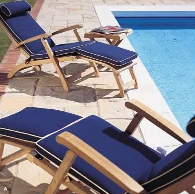70511 Barbuda Double Steamer Set with optional cushions angled one right side view and other on left side view side table with magazine on pool deck with pool in background