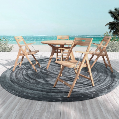 70804 Surf Marine Grade 42 inch round Folding Dining Set for 5 showing Surf  42 inch Round Tale and 4 Folding Armchairs angled on wood deck with ocean and blue sky in background