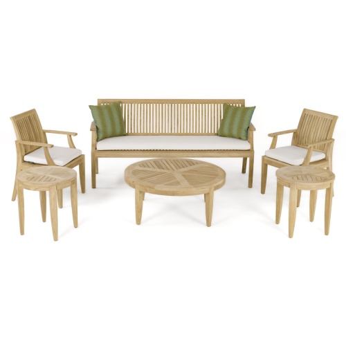 70849 Laguna 6 piece teak set showing a 6 foot teak bench with seat cushions and two throw pillows and 2 teak Armchairs with cushions 2 side table and coffee table on white background