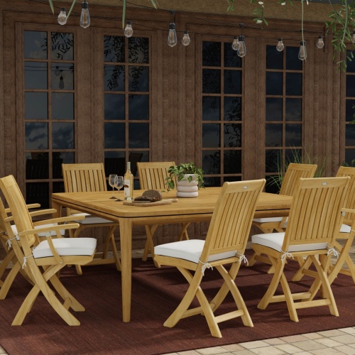 70865 Veranda Barbuda Teak Dining Set with wine bottle and 2 glasses and bread on wood board and potted plant and Barbuda Teak Dining Chairs with optional seat cushions on covered tiled patio 