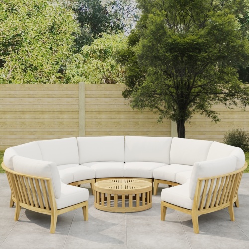 70870 Kafelonia Lounge Sofa 6 pc Set showing partial view of  Kafelonia Sofa Sectional Bench and a Teak Coffee Table angled top on tiled patio with wood fence and trees in background