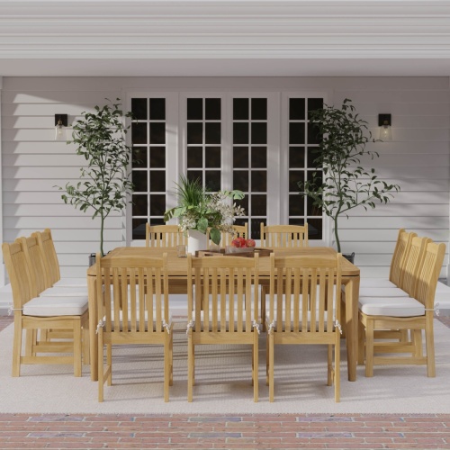 70879 Veranda 13 piece teak Square Dining Set of 12 teak side chair and 6 foot square dining table with bowl of apples on covered lanai with potted plants and french doors in background 