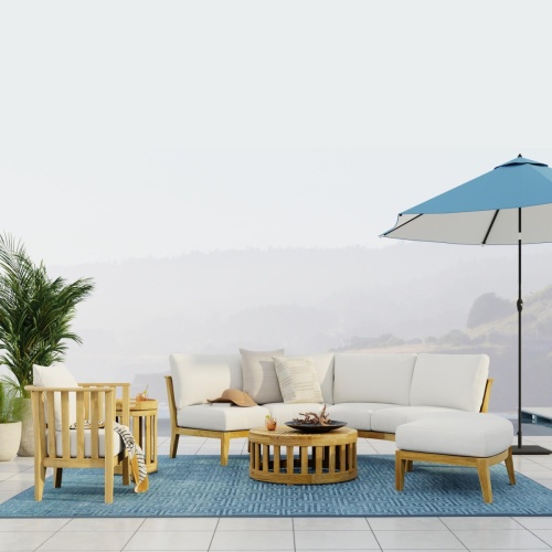 70929 Kafelonia 6 piece Sofa Sectional Set front view on outdoor terrace one side lined with 2 potted plants next to open optional umbrella with fog and hills in background