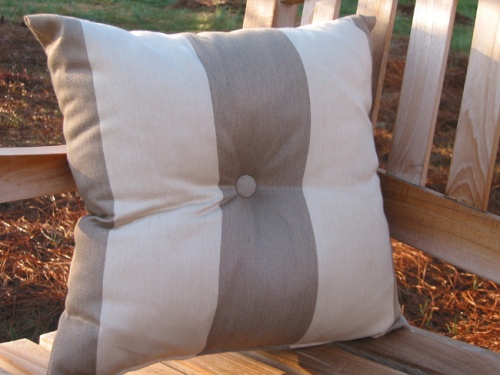 71000MTO Solid Color Throw Pillow set on teak bench with grass background