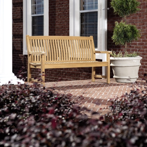 13618 Veranda Teak 5 foot long Bench on concrete stone patio with house windows in background
