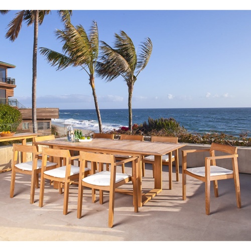 70220 Horizon 9 piece Teak Dining Set on concrete patio overlooking ocean with condo on right