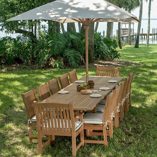 17640 grand ten foot open rectangular teak umbrella in dining set on grass with apples bread plates and bowls on top with trees dock and water view in background