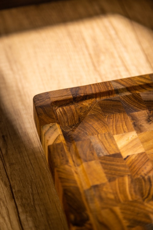 19124 Butcher Block 20 inch Rectangle Cutting Board showing closeup side view on a counter top