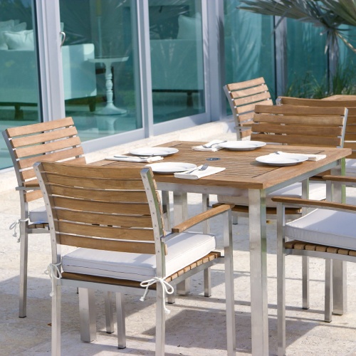70014 Vogue teak and stainless steel 5 piece Dining Set closeup view with 4 place settings and glass sliding doors in background