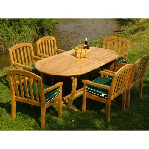 70068 montserrat curve nine piece cushioned oval dining set basket wine and glasses top angle view on green grass lawn with creek and vegetation background