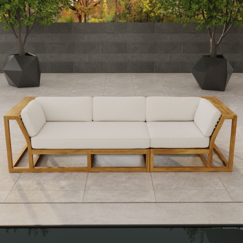 70277 Maya Deep Seating Sofa of Maya Right Side Sofa Sectional and Corner Sectional in angled front view on patio facing a pool with fence and trees in background