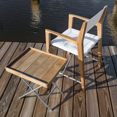 70461 odyssey teak and stainless steel folding chair and ottoman side table aerial angled view on dock and water in background
