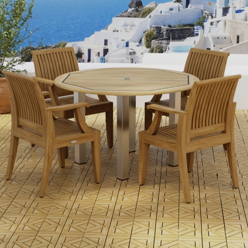 70620 Vogue Laguna Dining Set in angled side view on teak parquet tiled terrace next to potted plant overlooking Mediterranean hillside homes and ocean in background