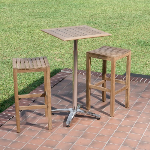 70670 Somerset teak Pub Bar Table and 2 teak Backless Barstools on wood deck with grass lawn background