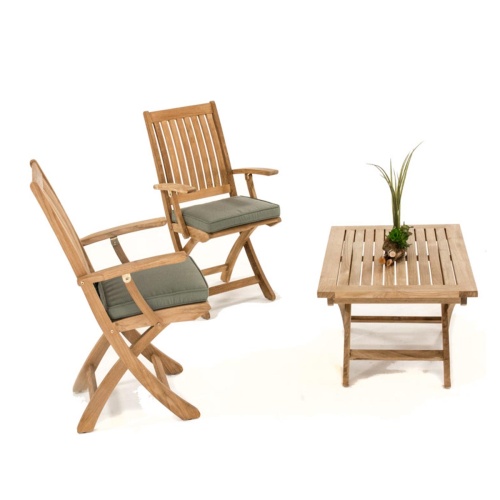 70729 Barbuda Chat Set with optional seat cushions and green plant on coffee table angled on white background