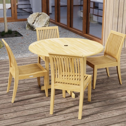 70732 Barbuda Laguna 5 pc Teak Dining Set in angled top view on patio with trees and landscape rocks and french doors and windows of house in the background