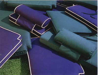 Image of 72569MTO Navy Blue color cushions and neckrolls  lying on green Terf grass