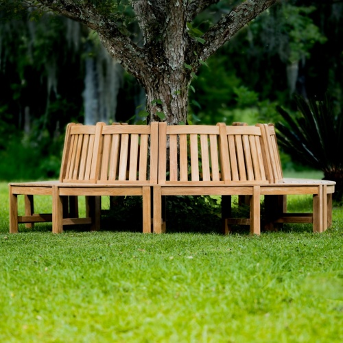 13691 Teak Tree Hugger Bench 5 sections around tree on grass with trees in background