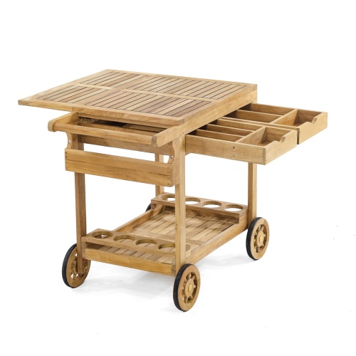 17105 Alicante teak Trolley Cart with top flap opened 2 pulled out drawers bottom shelf with 8 wine bottle holders rubber lined wheels for mobility angled view on white background