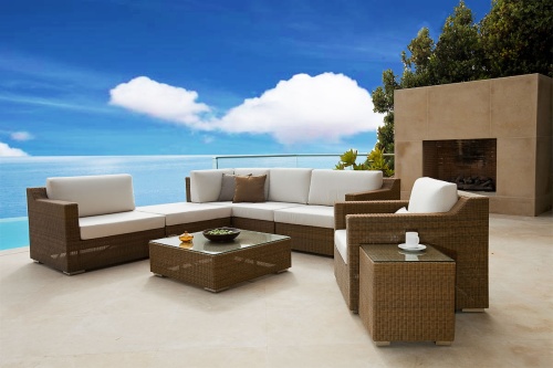 31006 malaga sofa sectional set on concrete patio with cup and saucer and bowls on tables with fireplace and trees and ocean in background