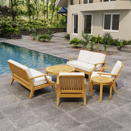 70347 Laguna 6 pc Sofa Set on paver patio next to a pool with house and landscaping plants and woods in background