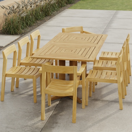 70462 Pyramid Horizon 9 pc Teak Dining Set of Pyramid Rectangle Dining Table and 2 Horizon Dining Armchairs and 6 Side Chairs in angled end view on patio with landscape plants in background