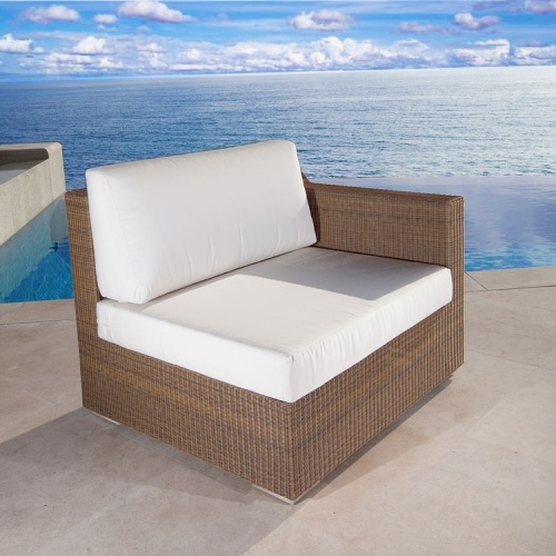 70508 malaga woven wicker left side sectional with canvas colored cushions next to pool on patio with ocean background