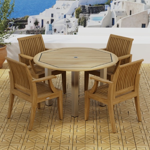 70620 Vogue Laguna Dining Set in angled aerial view of table top on teak parquet tiled terrace next to potted plant overlooking Mediterranean hillside homes and ocean in background