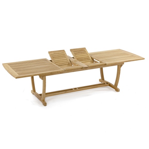 70731 Surf Veranda teak rectangular table with two butterfly leaf extensions folded in v position in storage area of table side angled on white background