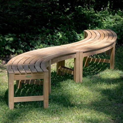70793 Teak Buckingham Curved Backless Bench showing 2 in S shape on grass lawn with shrubs in background