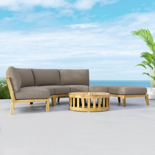 70934 Kafelonia 4 piece Curved Sofa Sectional Set front view on an outdoor patio in angled front view with ocean in the background