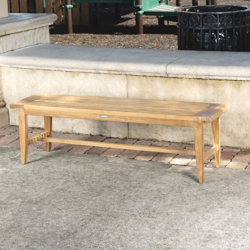 13916 Laguna Teak 5 foot Backless Bench angled view on concrete stone patio with concrete low wall in background