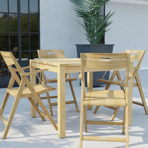 70147 Surf 36 inch Square Teak Dining Set in side view on a stone patio with potted plant and window in background