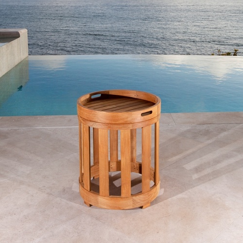 70239 kafelonia teak side table with teak tray attached on stone patio with pool ocean and blue sky in background