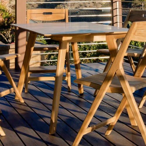 70518 Surf teak 7 piece folding Dining Set on wood deck close up view with natural vegetation in background