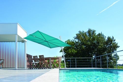 sps25100ffb spectra solo umbrella only  on pool deck over dining set next to covered area pool in front of set trees and blue sky in background