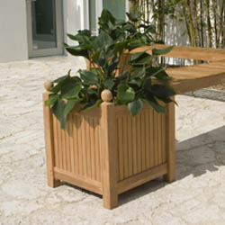 18109 square planter box angled view on concrete patio with shrubs in background