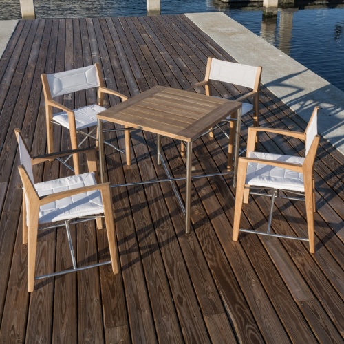 25815 Odyssey Teak and Stainless Steel 32 Inch Square Outdoor Folding Table with 4 Odyssey Chairs aerial view on boat dock