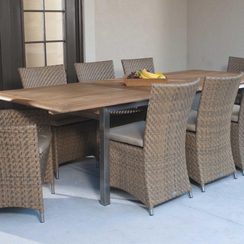 70247 Vogue Valencia 9 piece Dining Set on paver outdoor patio with a square teak tray of fresh fruit on table and patio doors in background