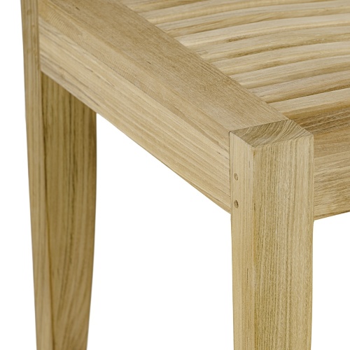 70435 Pyramid teak rectangular dining table close up of seat and leg join on white background