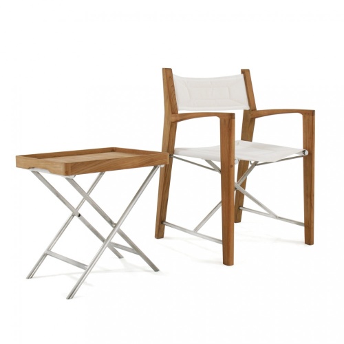 70466 Odyssey teak directors folding chair with natte colored sunbrella fabric and teak and optional folding stainless steel side table angled on white background