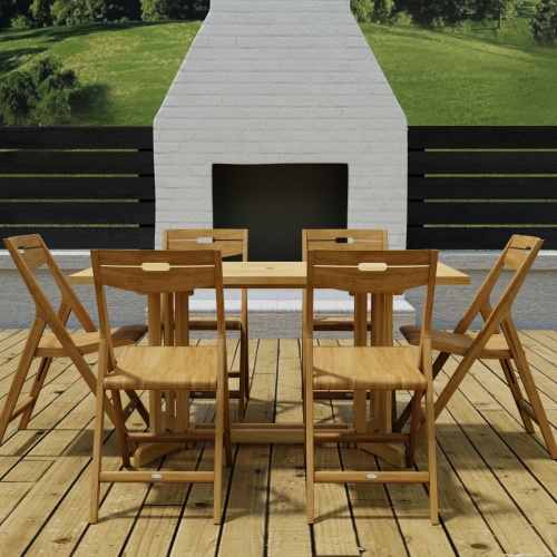70472 Surf Nevis Teak 7 pc Dining Set of Nevis Dining Table and 6 Surf Folding Chairs in side view on wood deck in front of a fireplace and fence with the hillside in background