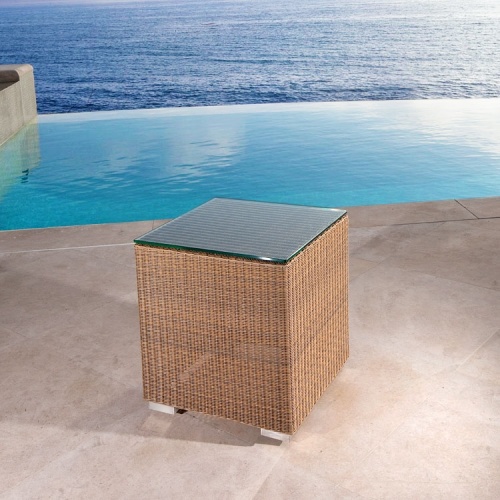 70508 malaga woven wicker side table stool with glass top next to pool on patio with ocean background