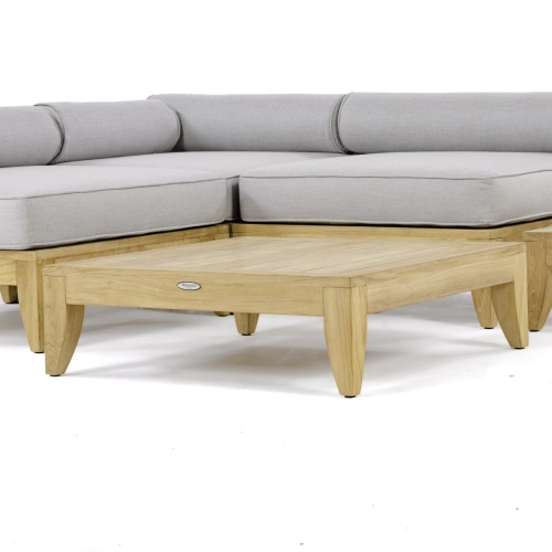 14315 aman dais teak coffee table with the aman dais sectional set on a white background