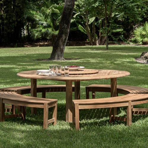 70090 Buckingham Picnic Dining Set showing teak lazy susan with Wine Glasses in center sitting on a wooden deck overlooking mountains and field