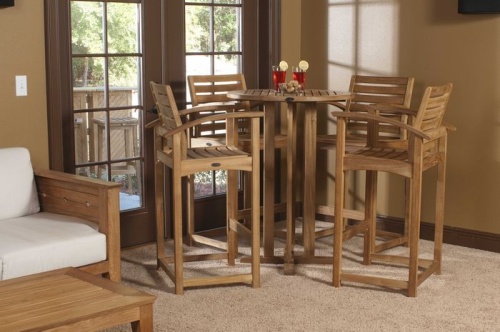 12466 Somerset 5 piece Teak Pub Table with two glasses of ice tea and bowl of snacks and teak stools on rug inside by patio doors
