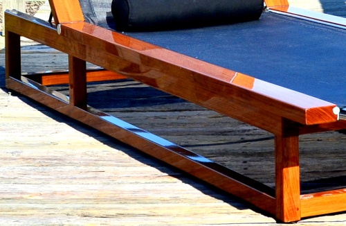 16771dp Maya teak Sling Lounger in black textilene mesh fabric in our marine gloss finish front view on a wooden deck