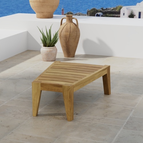 14918 Kafelonia Teak End Table in angled top view on tiled terrace with 3 potted plants against wall with home and ocean in background
