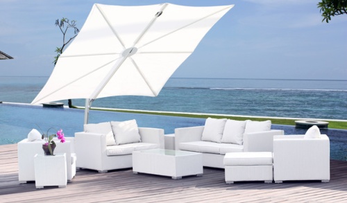 sps25100ffb spectra solo umbrella only with white canopy angled up on terrace over deep seating set flowering orchid plant with pool grass area ocean and blue sky in background