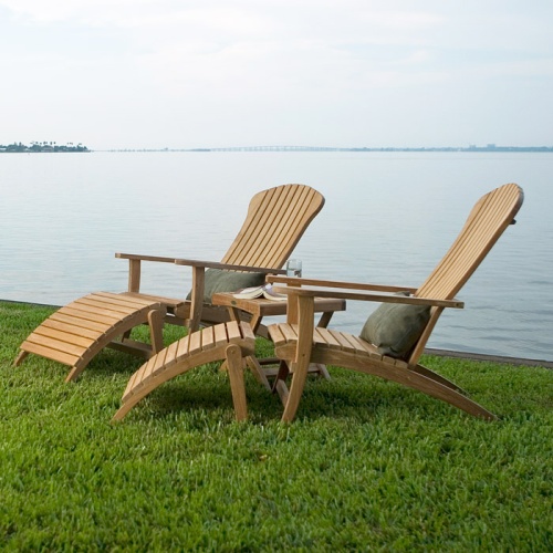 70000 two Adirondack Chair with footrest and cushions side view on green grass in front of lake